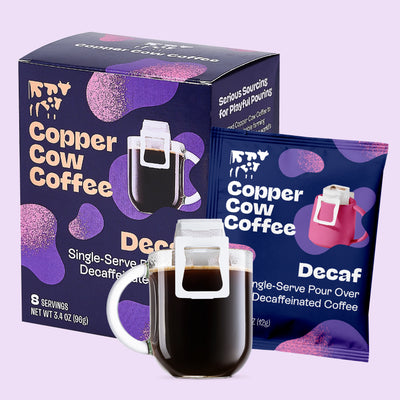 Copper Cow Coffee Decaf packaging with a mug filled with coffee on a light purple background