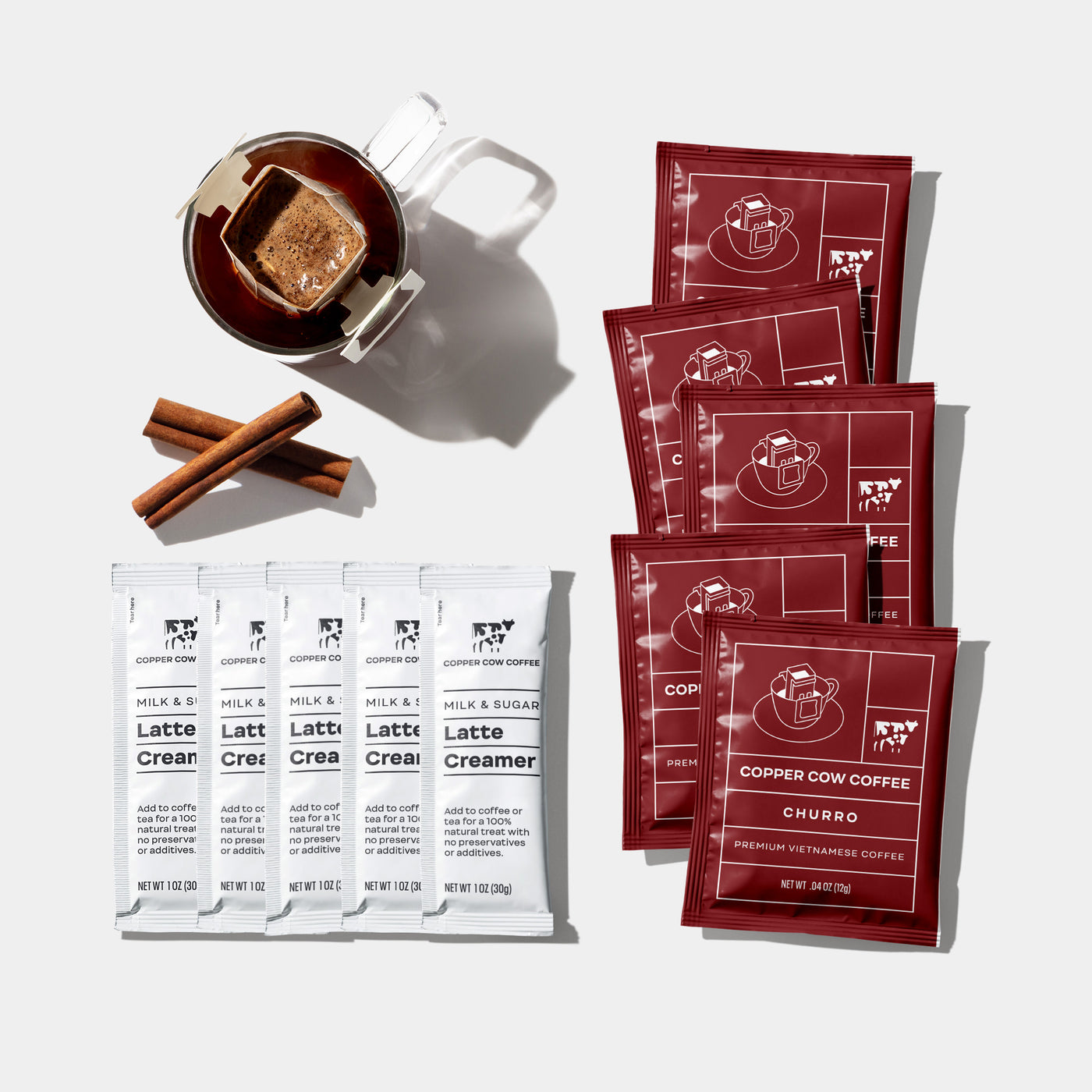 https://coppercowcoffee.com/cdn/shop/products/B-BESTSELLER022-gift-set-vietnamese-coffee-creamer-box-contents-churro-latte-copper-cow-coffee_1400x.jpg?v=1686599263